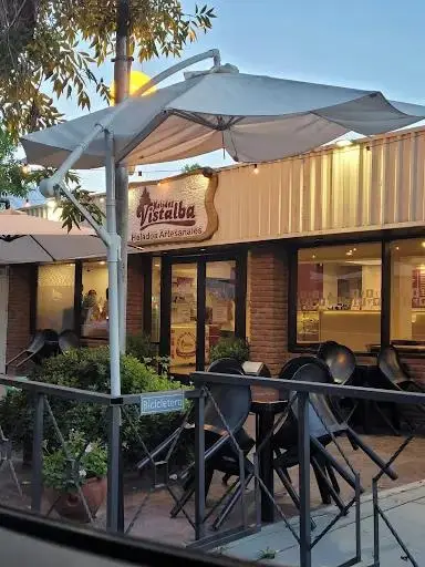 El local de Helados Vistalba al atardecer, con sombrilla, luces cálidas y mesas afuera